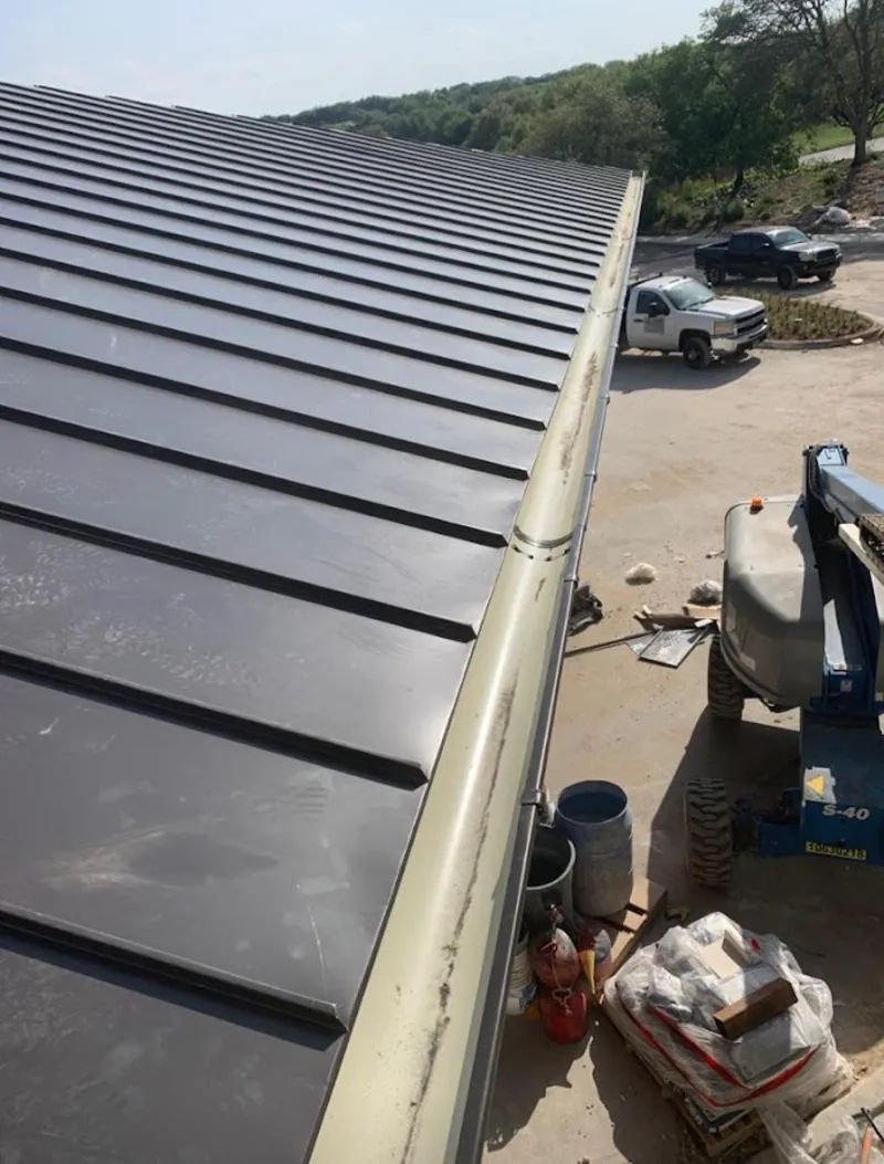Standing seam panel and gutter detail on a metal roofing jobsite in Dawsonville